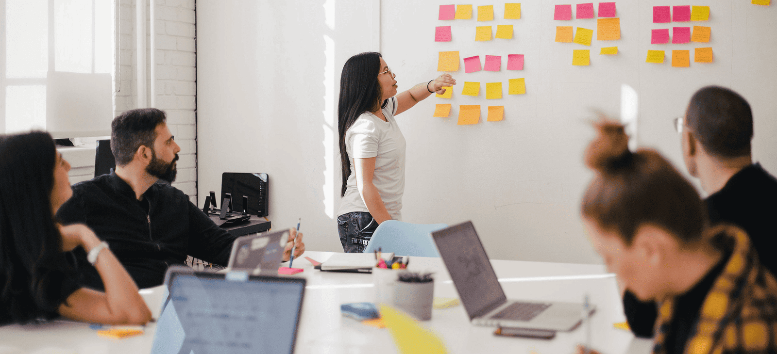 Digital strategy team planning a market launch on a workshop wall